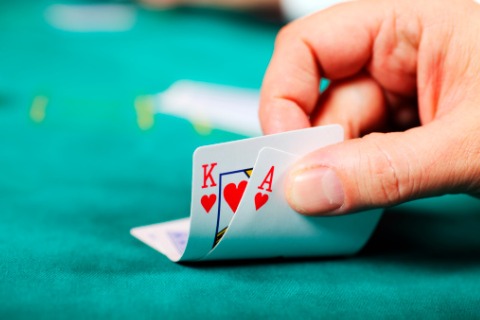 A user checking out the great hand he was delt playing poker.
