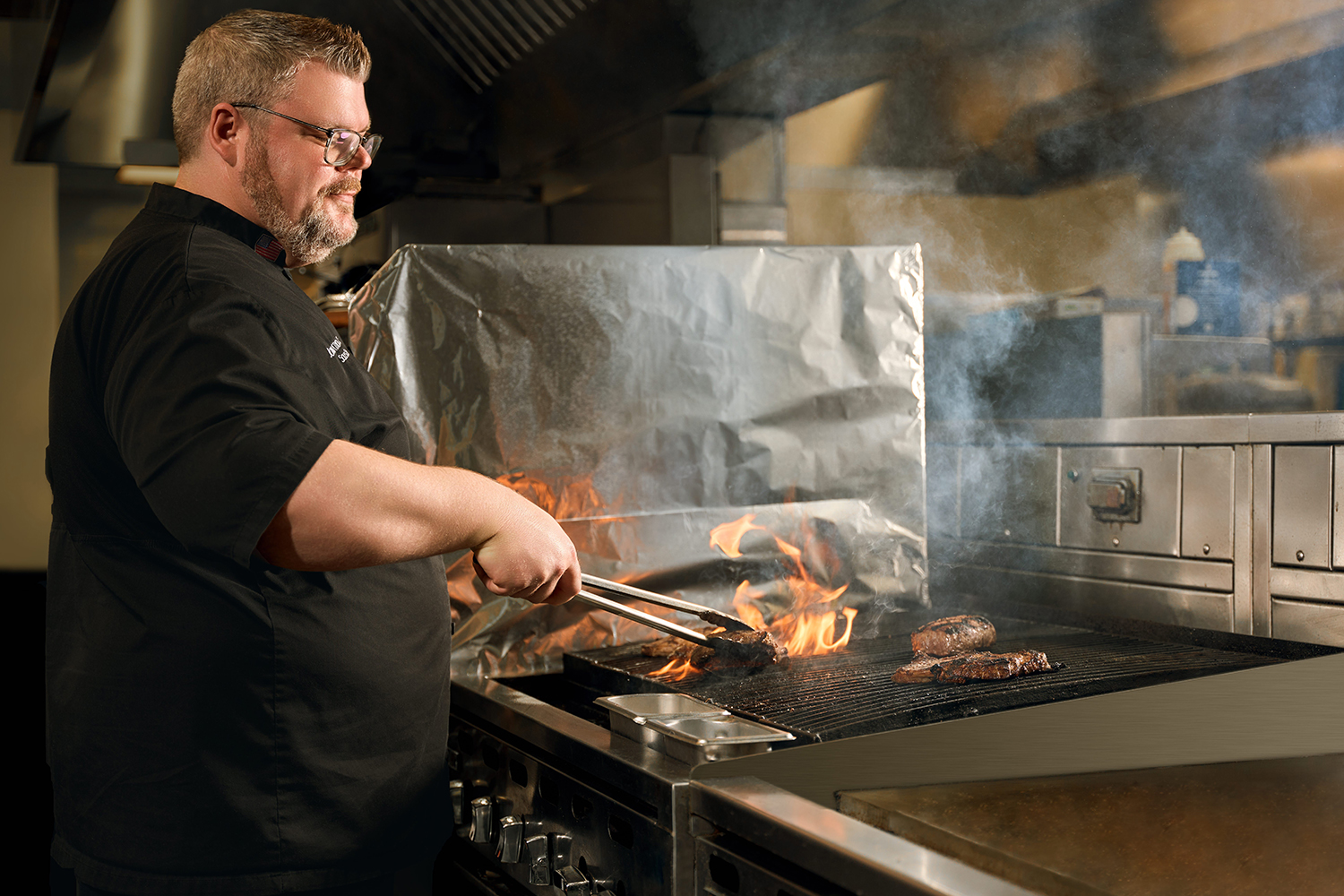 A chef cooking steak at the 360 Restaurant in the Apache Casino Hotel